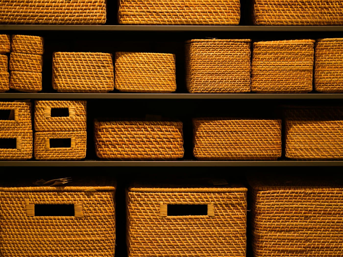 Stackable storage baskets arranged neatly on a shelf, grouping small everyday items instead of leaving them scattered across a surface.