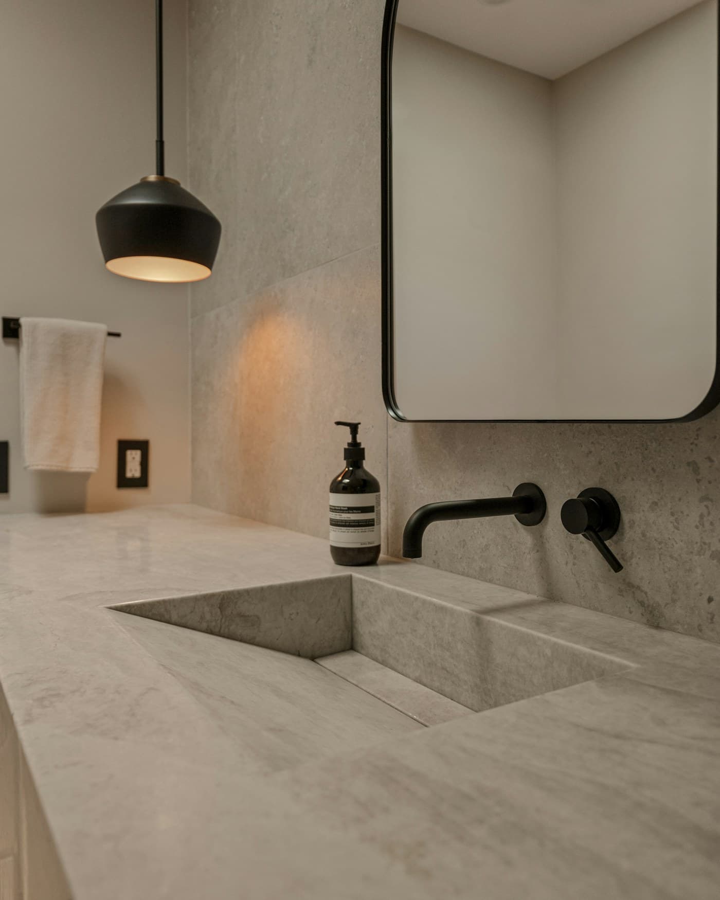 A small, organized bathroom with matching storage containers and wall-mounted shelving.
