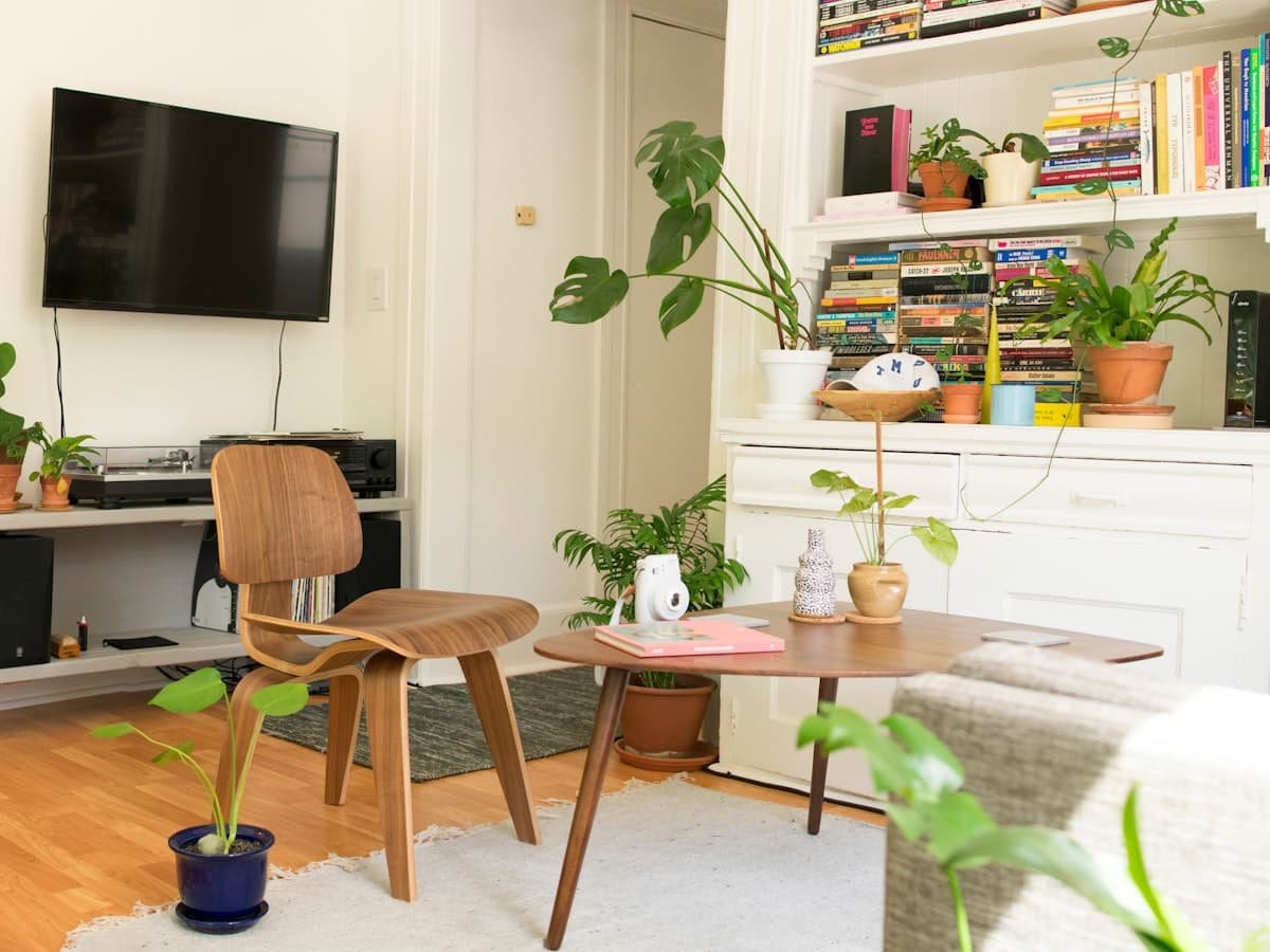 A compact, multifunctional living room corner with a media unit, armchair and layered storage.